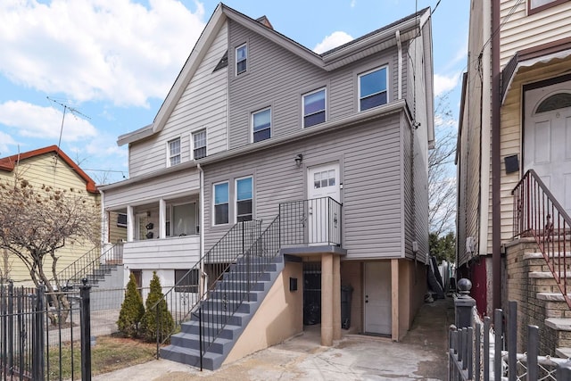 townhome / multi-family property featuring stairs and fence