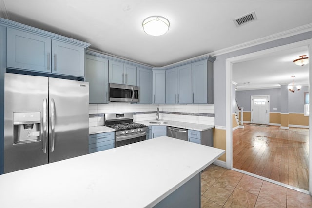 kitchen with stainless steel appliances, visible vents, light countertops, tasteful backsplash, and crown molding