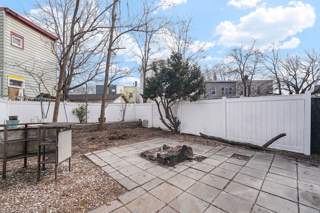 view of patio / terrace with a fenced backyard and a fire pit