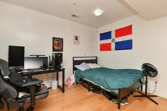 bedroom with wood finished floors and visible vents