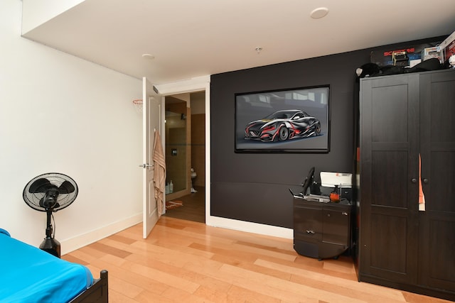bedroom featuring light wood-type flooring and baseboards