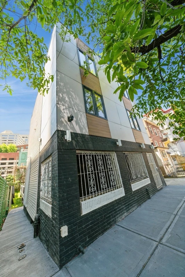 view of property exterior with brick siding