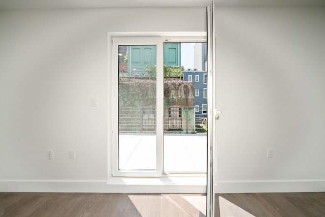 entryway featuring wood finished floors and baseboards