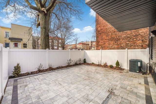 view of patio featuring central AC unit and a fenced backyard