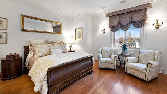 bedroom with ornamental molding and dark hardwood / wood-style floors