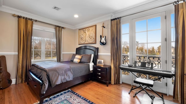 bedroom featuring ornamental molding and light wood-type flooring