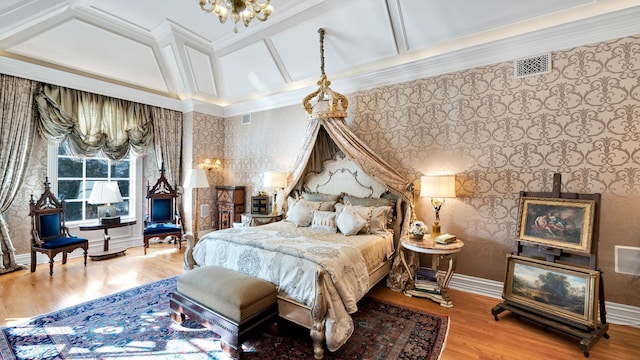 bedroom with wood-type flooring, beam ceiling, crown molding, and coffered ceiling