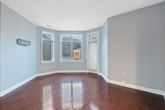 unfurnished room with dark hardwood / wood-style flooring