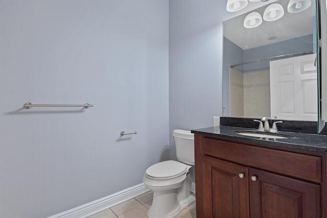 bathroom featuring vanity, a shower, tile patterned floors, and toilet