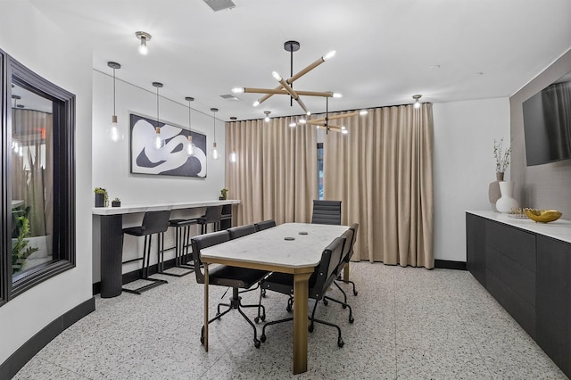 dining area with an inviting chandelier