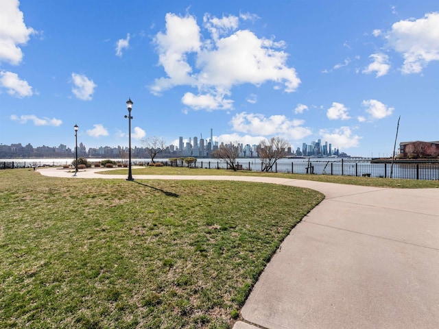 view of home's community featuring a yard and a water view