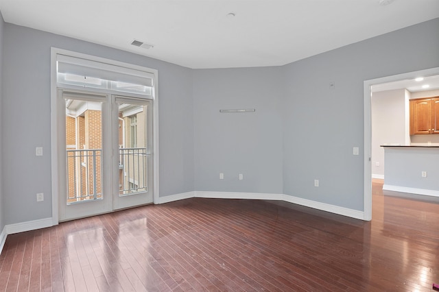 unfurnished room with hardwood / wood-style flooring