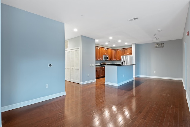 kitchen featuring stainless steel appliances and dark hardwood / wood-style floors