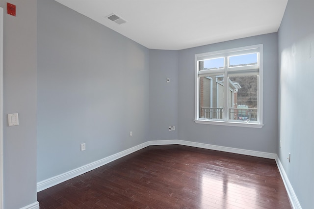 unfurnished room with dark wood-type flooring