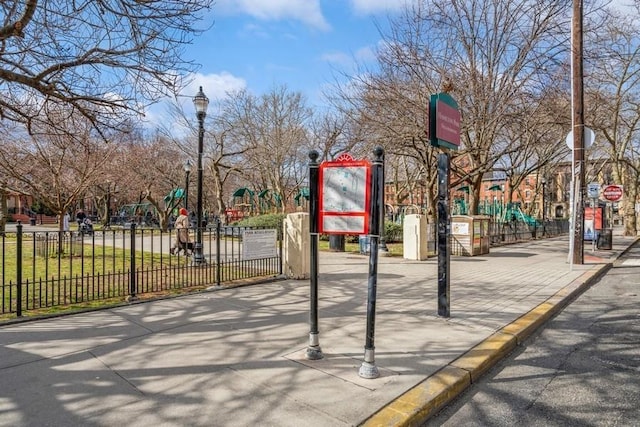 view of community with playground community and fence