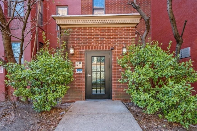 entrance to property featuring brick siding