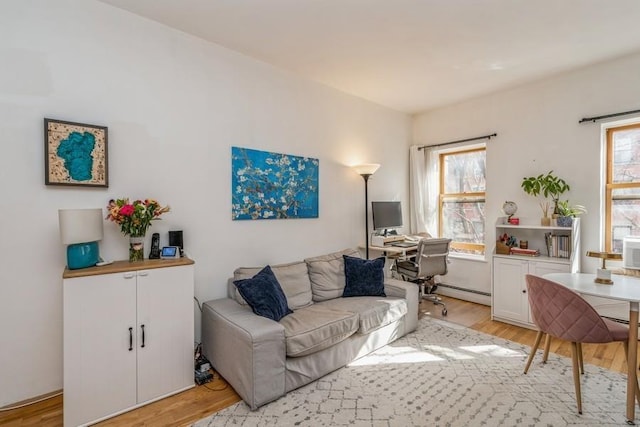 living area featuring light wood-type flooring and a baseboard radiator