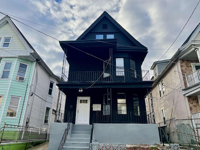 victorian-style house with a porch and a balcony