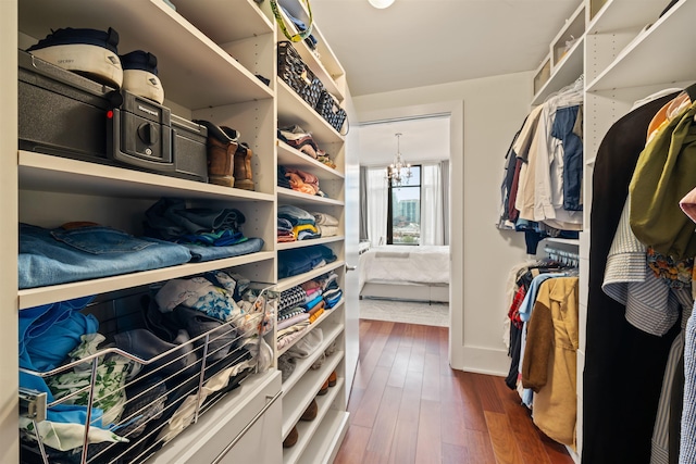 84 Willow Ave Unit 4B, Hoboken, NJ 07030 - walk in closet with dark wood-style floors and a chandelier