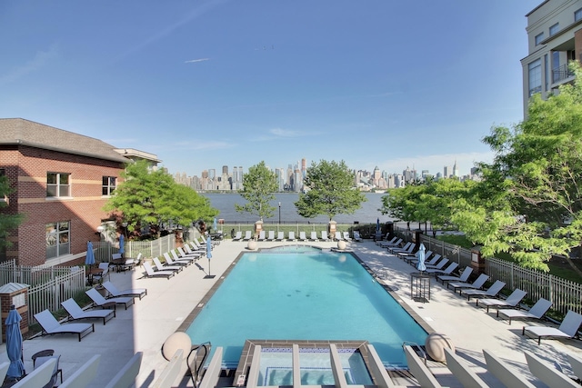 24 Ave At Port Imperial Unit 305, West New York, NJ 07093 - community pool featuring fence, a water view, a patio area, and a view of city