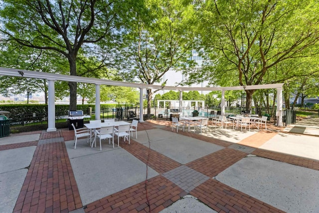 view of property's community with fence and a patio