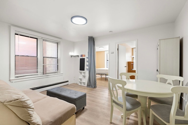 living room with light wood-style flooring and a baseboard radiator