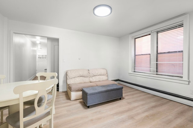 living area featuring light wood-style flooring and a baseboard radiator