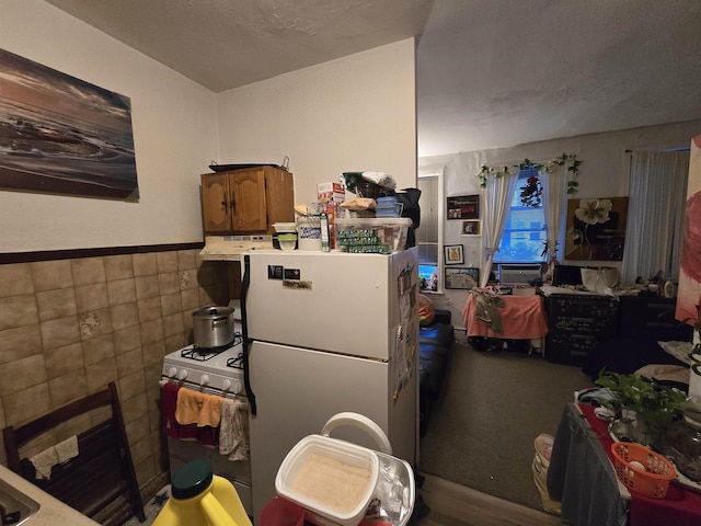 207 48th St Unit 4Aka 2A, Union City, NJ 07087 - kitchen with tile walls, white appliances, wainscoting, and under cabinet range hood