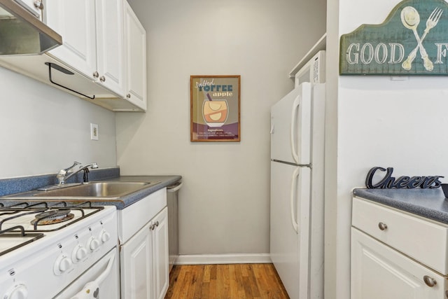 kitchen featuring under cabinet range hood, light wood-style floors, white appliances, white cabinetry, and a sink