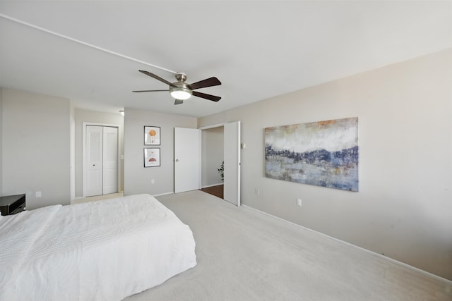 carpeted bedroom featuring a closet and ceiling fan