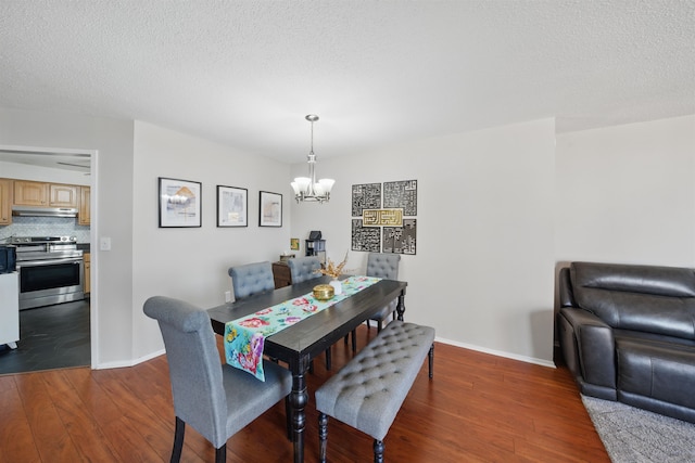 dining room with an inviting chandelier, baseboards, and dark wood finished floors