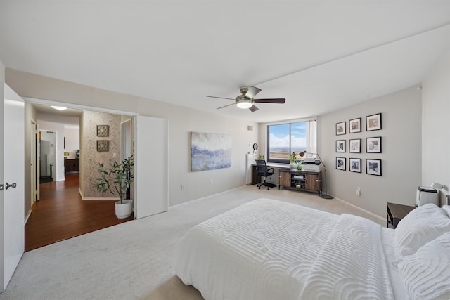 bedroom with a ceiling fan, carpet flooring, and baseboards