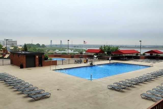 pool with fence and a patio