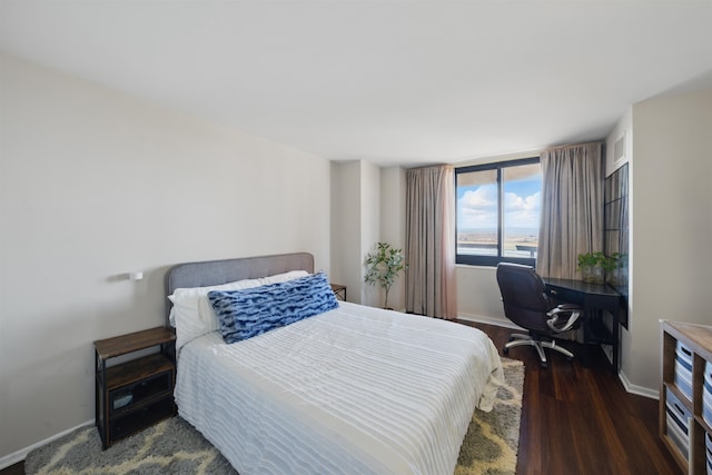 bedroom featuring wood finished floors and baseboards