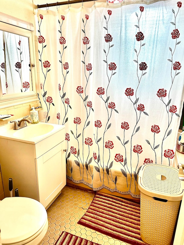 full bathroom with vanity, tile patterned floors, toilet, and shower / bathtub combination with curtain