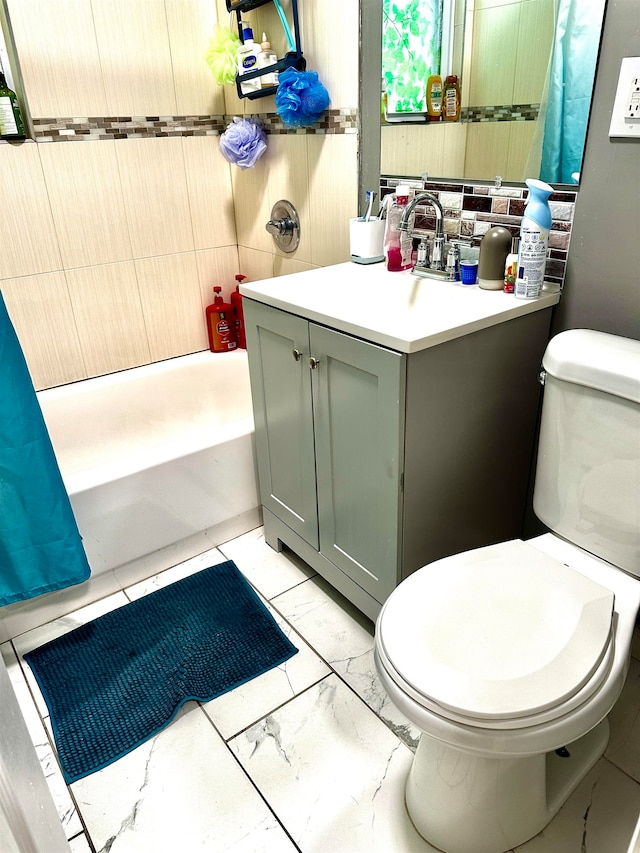 full bathroom featuring vanity, shower / bath combo with shower curtain, and toilet