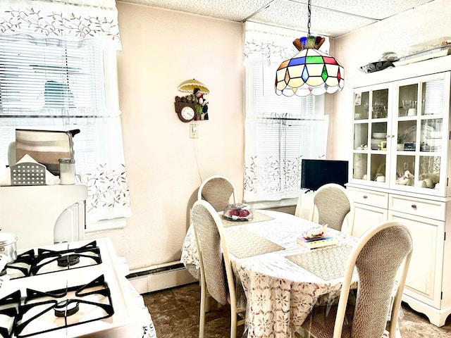 dining room featuring a baseboard radiator and a paneled ceiling