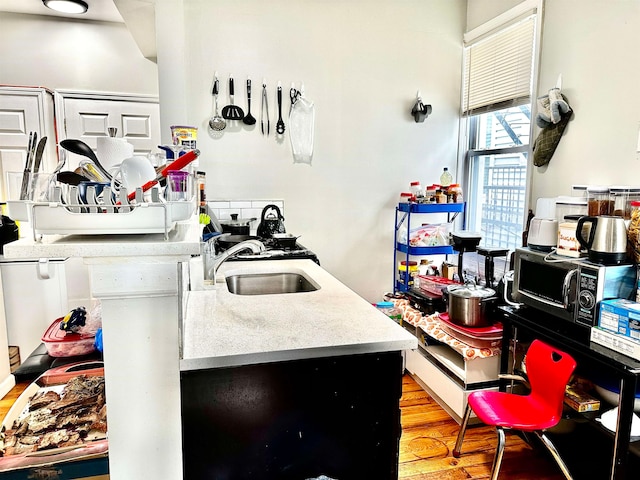 kitchen with sink and light hardwood / wood-style flooring