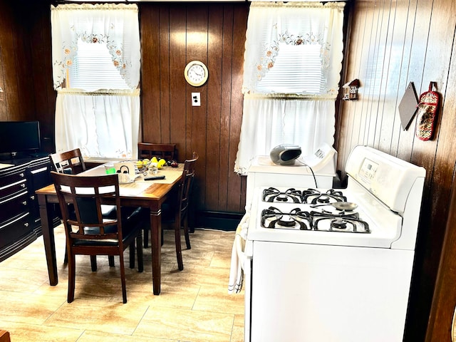 kitchen featuring wooden walls and washer / dryer