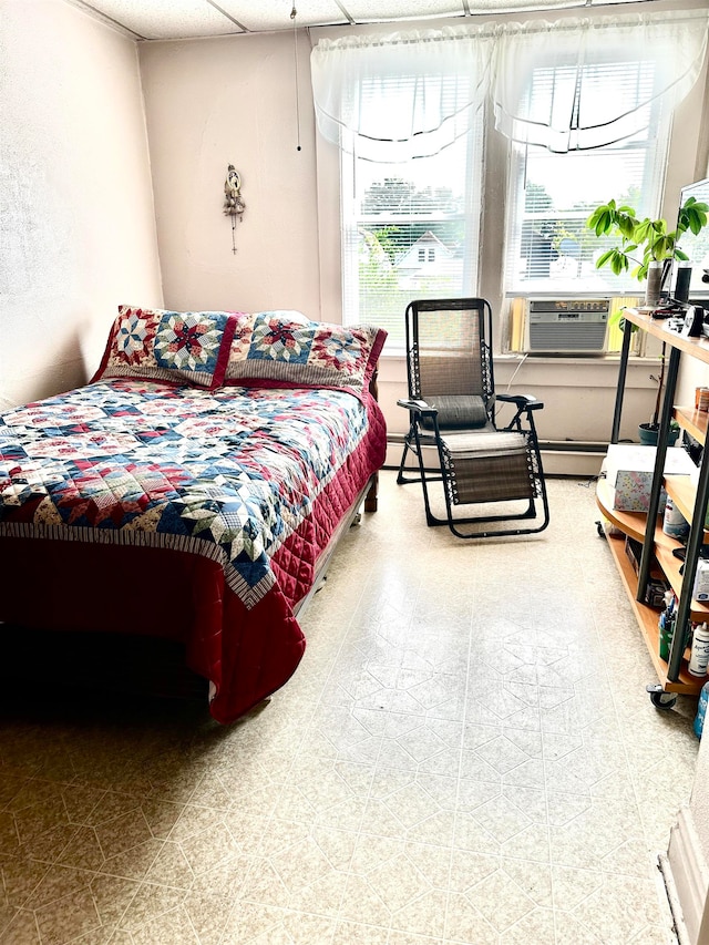 bedroom featuring baseboard heating and cooling unit