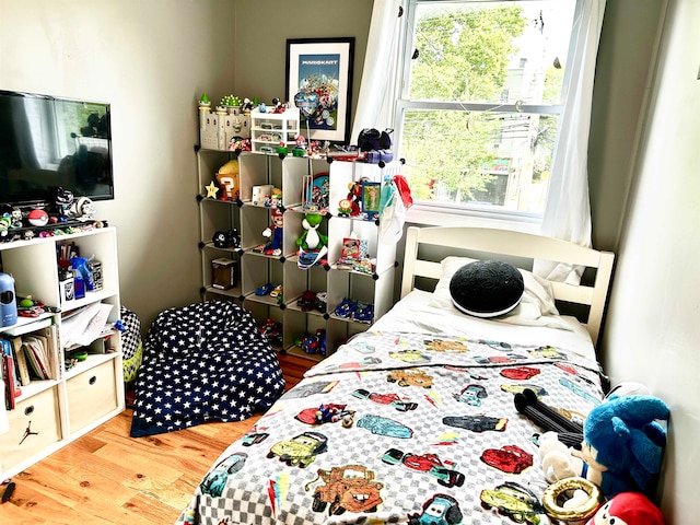 bedroom with hardwood / wood-style floors