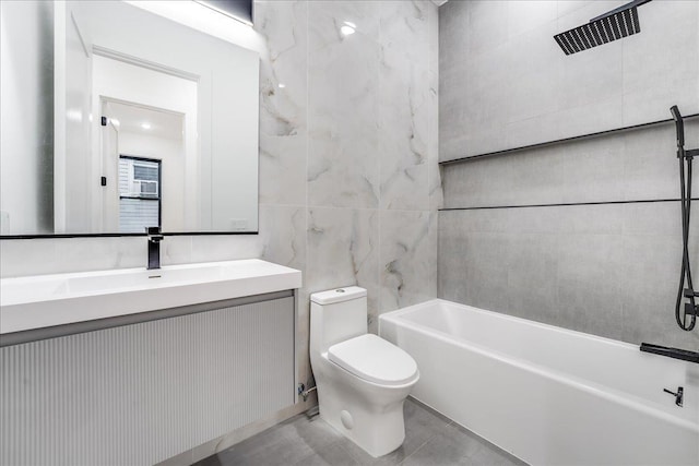 full bathroom with vanity, toilet,  shower combination, and tile walls