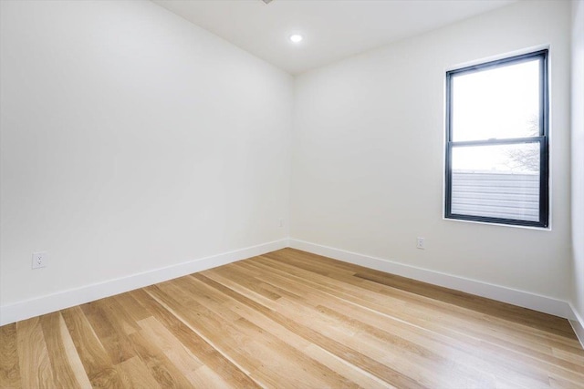 unfurnished room with hardwood / wood-style flooring