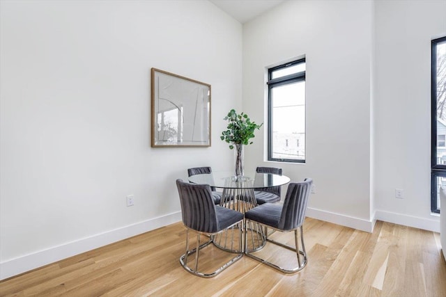 dining space with light hardwood / wood-style flooring