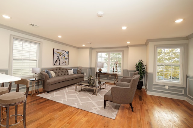 living room featuring light hardwood / wood-style floors and crown molding