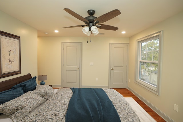 bedroom with ceiling fan and hardwood / wood-style flooring