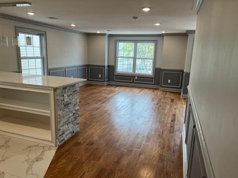 interior space with crown molding and dark hardwood / wood-style flooring