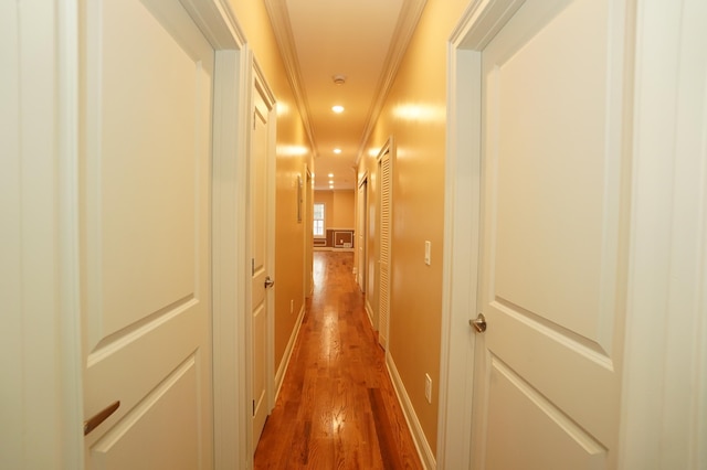 hallway featuring hardwood / wood-style flooring and crown molding