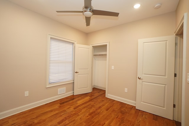 unfurnished bedroom featuring a closet, ceiling fan, and hardwood / wood-style floors