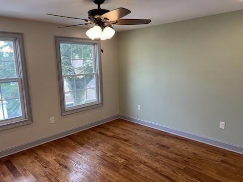 unfurnished room featuring a wealth of natural light, hardwood / wood-style floors, and ceiling fan